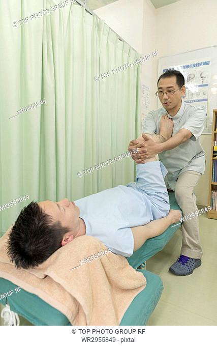 Doctor Manipulating the Legs of A Man