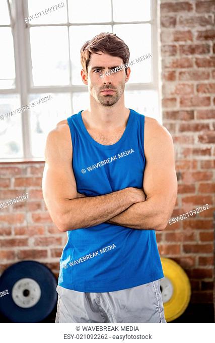 Portrait of muscular man with arms crossed