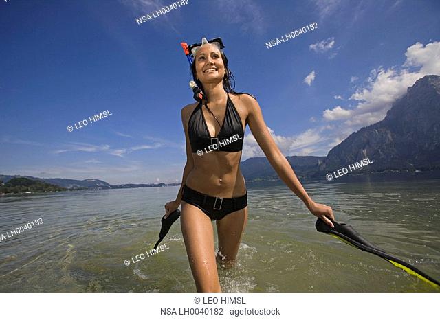 woman with snorkelling equipment at the lake