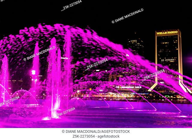 Friendship Fountain, Jacksonville, Florida, USA at night. Across the river can be seen downtown Jacksonville and the Jacksonville Landing