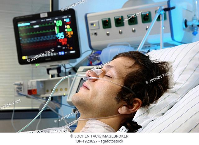 Patient lying in a special bed, being given artificial respiration through the nose, intensive care unit, hospital