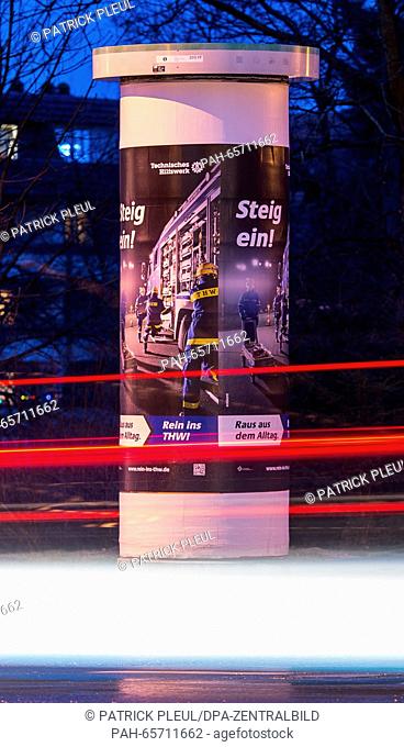A long-exposure shot shows light trails left by cars next to an advertising column in Frankfurt an der Oder, Germany, 08 February 2016