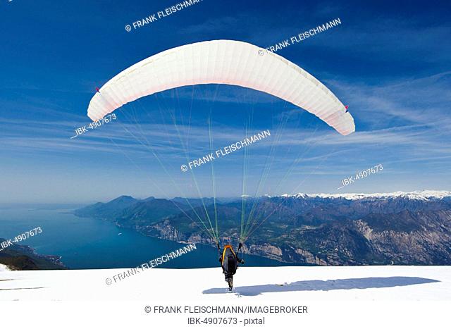 Launch of a paraglider on Monte Baldo above Lake Garda, Malcesine, Veneto, Italy