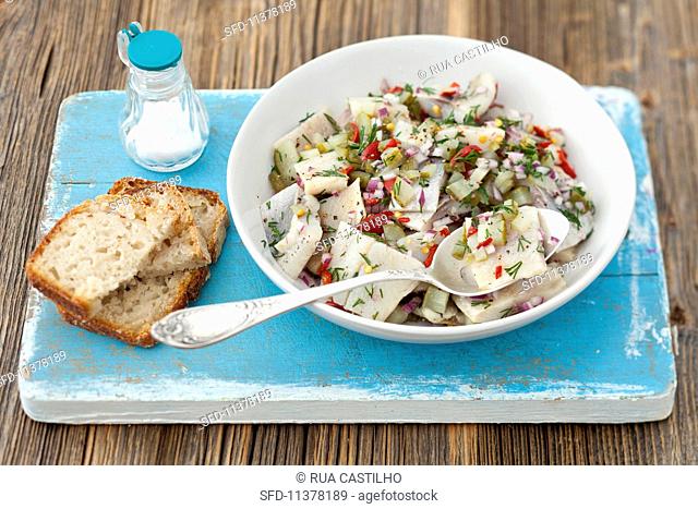 Herring salad with gherkins, chilli, onions and dill served with bread