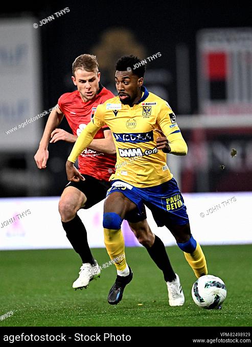 Rwdm's Klaus William and STVV's Joselpho Barnes fight for the ball during a soccer match between RWD Molenbeek and Sint-Truidense VV