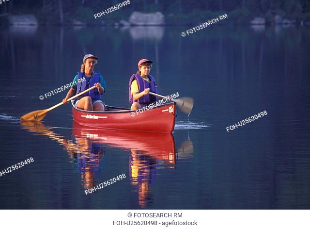 canoeing, canoe, Vermont, VT, Mother and daughter paddling a red canoe on Kettle Pond in Groton State Forest