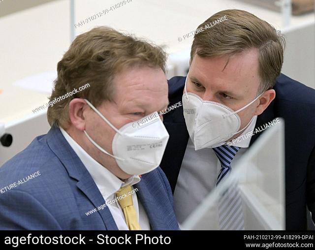 11 February 2021, Brandenburg, Potsdam: Steeven Bretz (r, CDU) and Andreas Noack (SPD) talk during the special session of the Brandenburg state parliament
