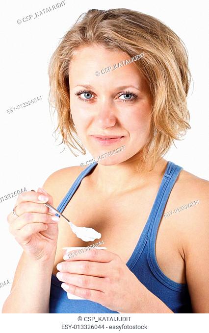 Young woman eating yoghurt