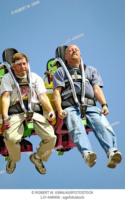 People on local carnival rides for fun during summer vacations at Florida State Fair US