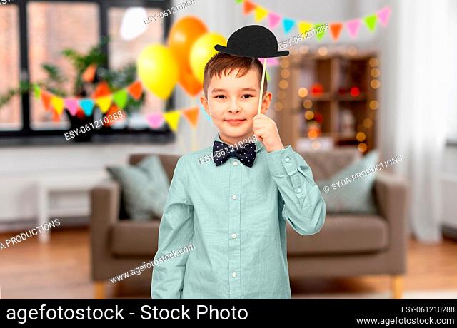 boy with birthday party props and bowler hat