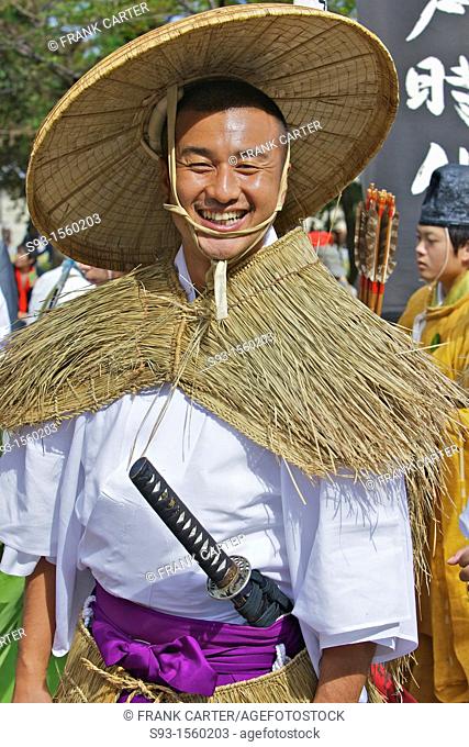A costumed participant in the Jidai Matsuri wearing a straw rain cape