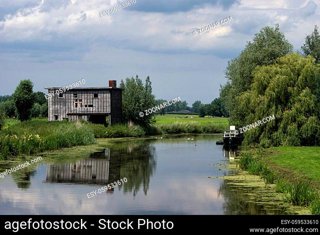 Run-down shed on the bank of the river Giessen near Hoornaar in the Dutch region Alblasserwaard