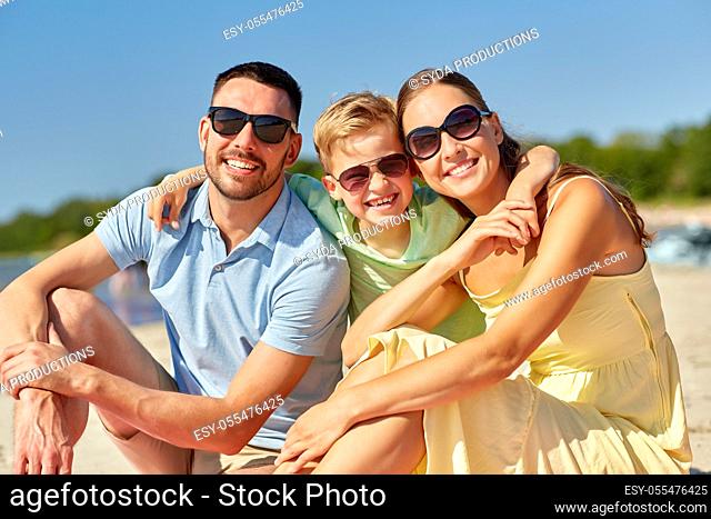 happy family hugging on summer beach