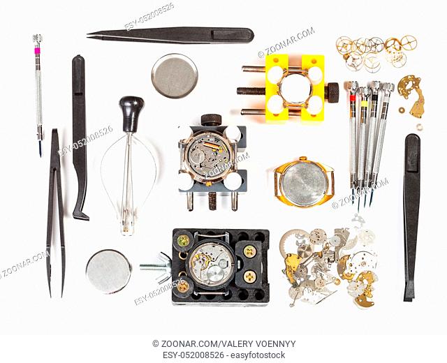 watchmaker workshop - top view of watch repairing tools on white background