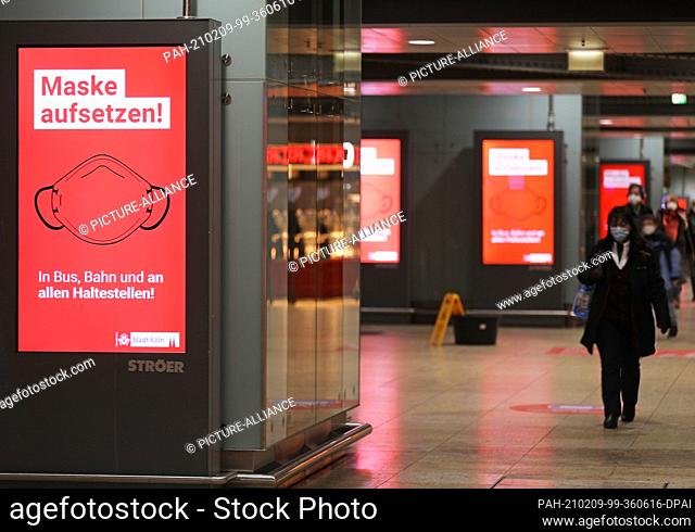 09 February 2021, North Rhine-Westphalia, Cologne: The words ""Put on your mask"" are written on a display at the main station