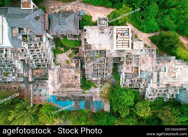 Aerial drone view of abandoned hotel on the beach of tropical island