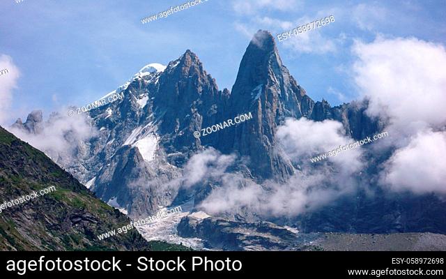 the Aiguille du Dru in the French Alps near Chamonix on a beautiful summer day with light cloud cover