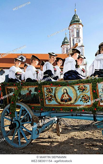 Germany, Upper Bavaria, Bad Tölz, Women sitting in horsedrawn at Leonhardi parade