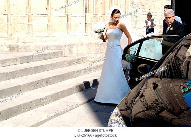Bride on steps in front of Basilica de Santa Maria del Mar, Barcelona, Spain