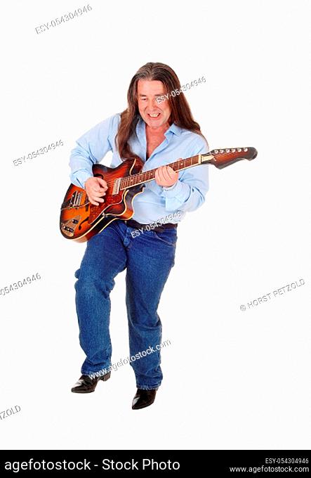 A happy musician playing his guitar with his long brunette.hair, singing, isolated for white background