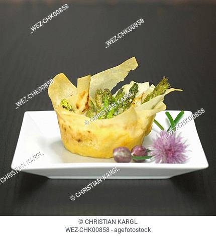 Puff pastry tartlet filled with green apsaragus, close-up