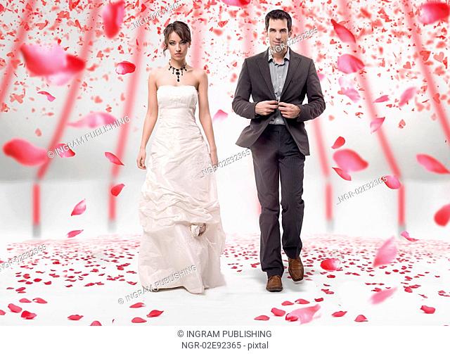 Wedding couple walking in roses