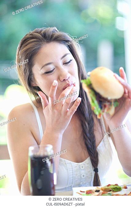 Young woman enjoying a burger