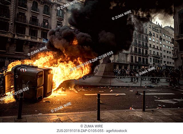 October 18, 2019, Barcelona, Catalonia, Spain: A trash container burns as Striking Catalan pro-independence activists protest the Supreme Court's verdict...