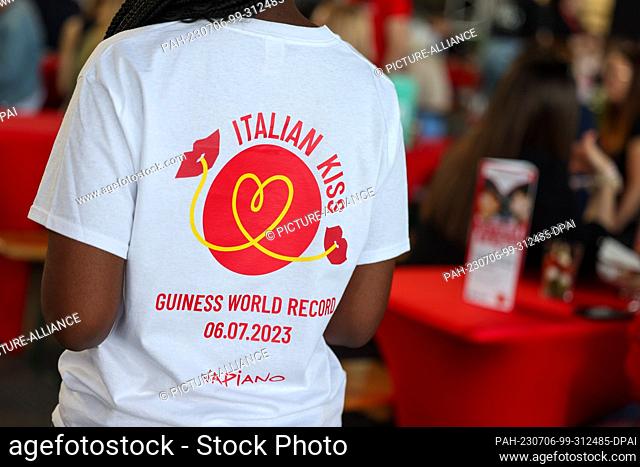 06 July 2023, Berlin: Waiters bring the pasta to the tables at the world record attempt ""Italian Kiss"" of the restaurant chain Vapiano at Tempelhof Airport