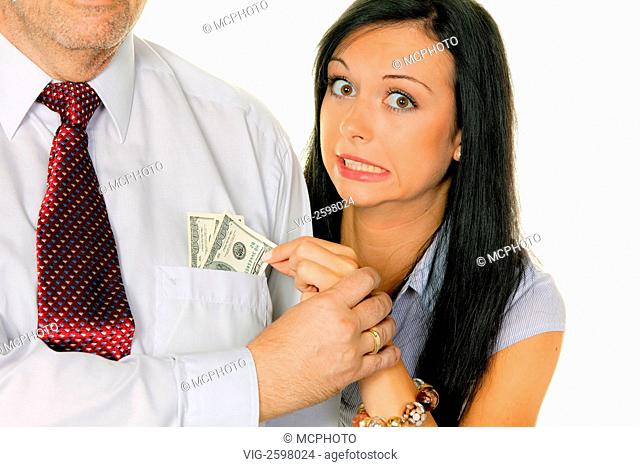 A young woman pulls the money out of a man's pocket. Dollar - 01/01/2011