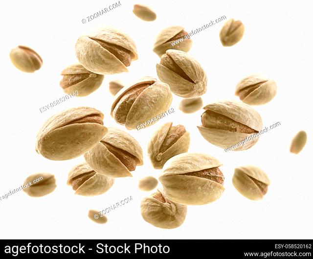 Salted pistachios levitate on a white background