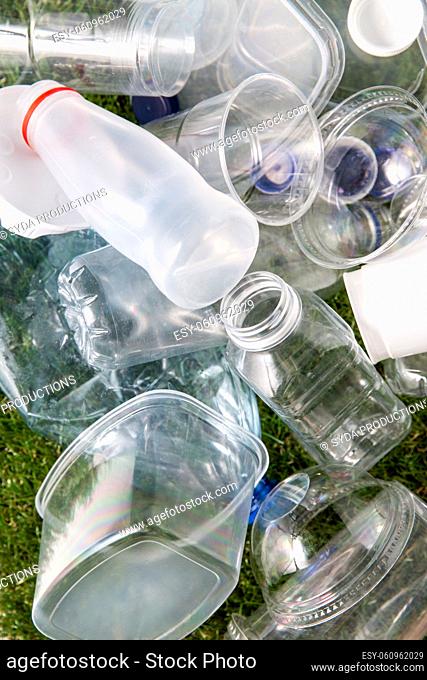 close up of empty used plastic bottles on grass