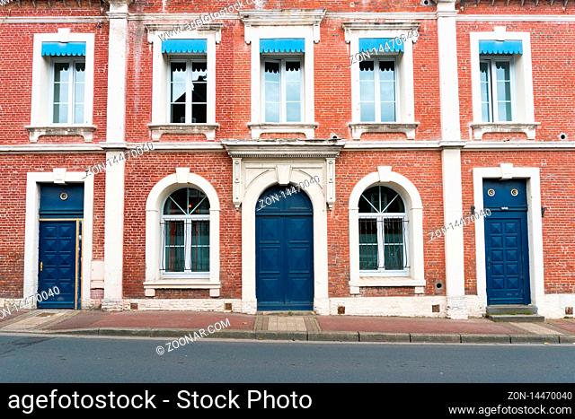 Etretat, Seine-Maritime / France - 14 August 2019: typical Norman stone and brick house front with colorful contrasts