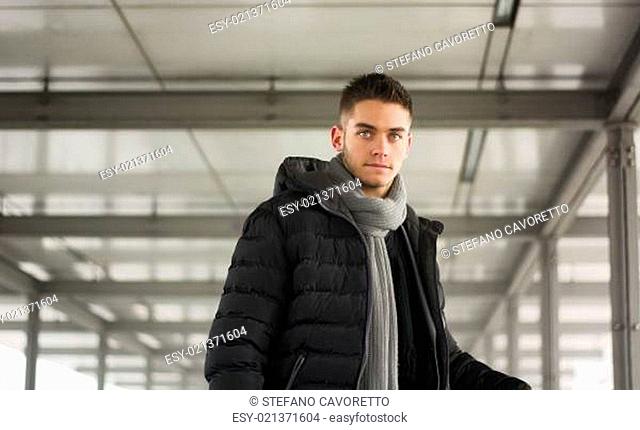 Attractive young man under tunnel in urban environment