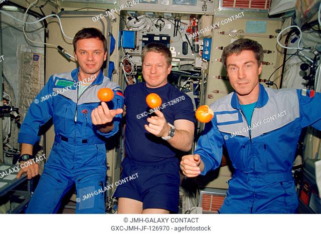 The Expedition 1 crew members are about to eat fresh fruit in the form of oranges onboard the Zvezda Service Module of the Earth-orbiting International Space...