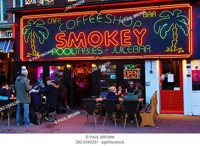 Neon lights on the sign of the Smokey Coffeeshop where taking and smoking drugs like marijuana is legal in Rembrandtplein in Amsterdam, Holland
