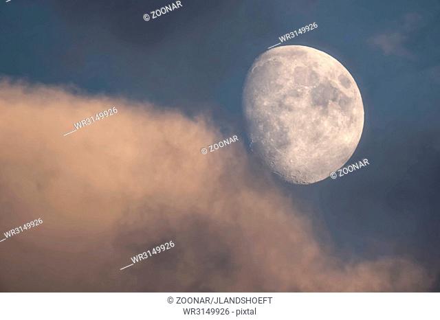 Waxing gibbous with clouds in the evening