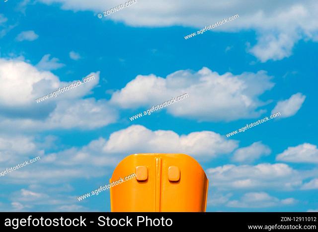 A binoculars and a cloudy sky at the day