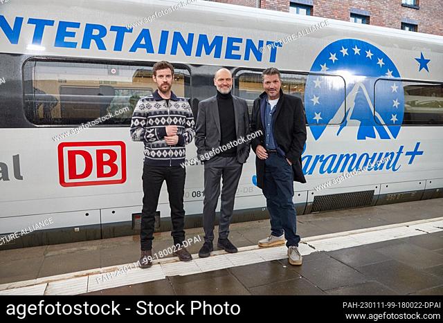 11 January 2023, Hamburg: Harry Treadaway (l-r), actor, Simon Beckett, author, and Hardy Krüger Jr., actor, stand on a platform at Altona station during a press...