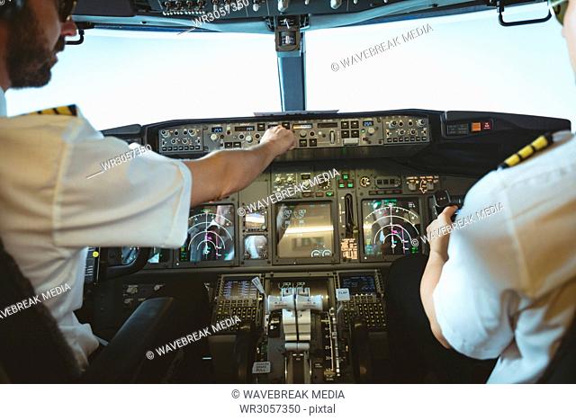 Pilot and copilot flying an airplane