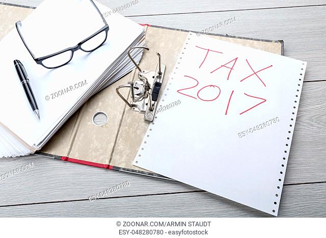 preparing an empty file folder for the tax clearance 2017