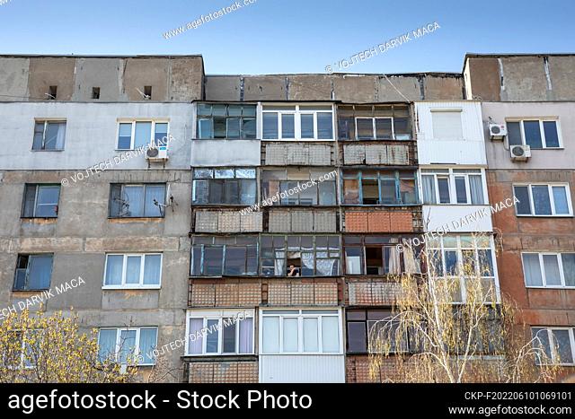 A man staring out of a block of flats right on the war line in the city of Avdiivka, pictured 24.04.2021 (CTK Photo/Vojtech Darvik Maca)