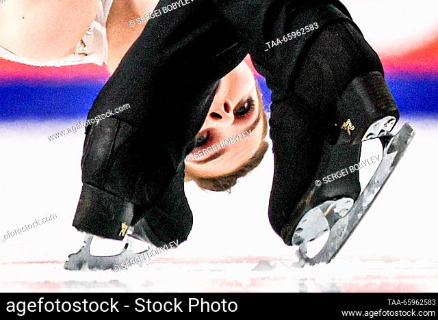 RUSSIA, CHELYABINSK - DECEMBER 21, 2023: Pair skaters Anastasia Mishina and Alexander Gallyamov perform a death spiral during a pairs' short programme event as...
