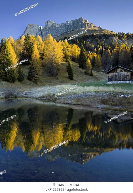 Rotwand and Rosengarten mountains with reflection in a mountain lake, Alto Adige, South Tyrol, Dolomites, Italy