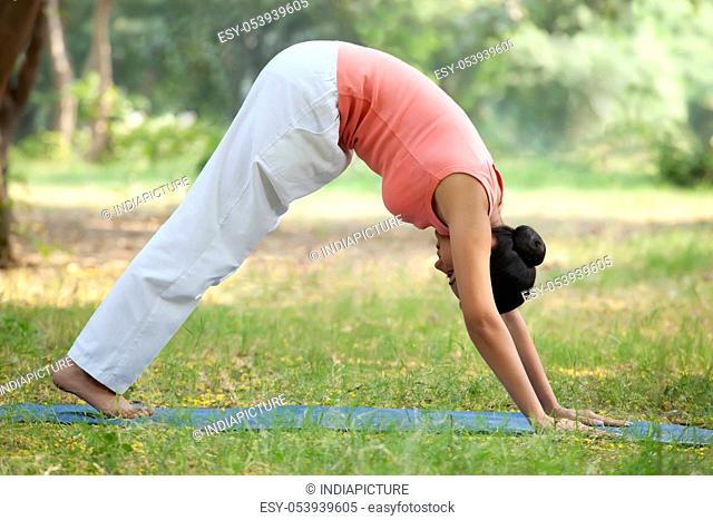 Woman in downward yoga pose