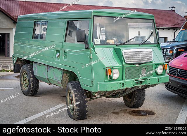 Zaton, Croatia, June 2019 Odd vehicle, most likely customised military Volvo 4x4 van from 70s, rusted, runed with flat tires. Front view