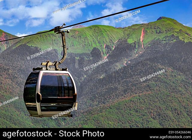 Cable car among the beautiful mountains in the ski resort during the summer season