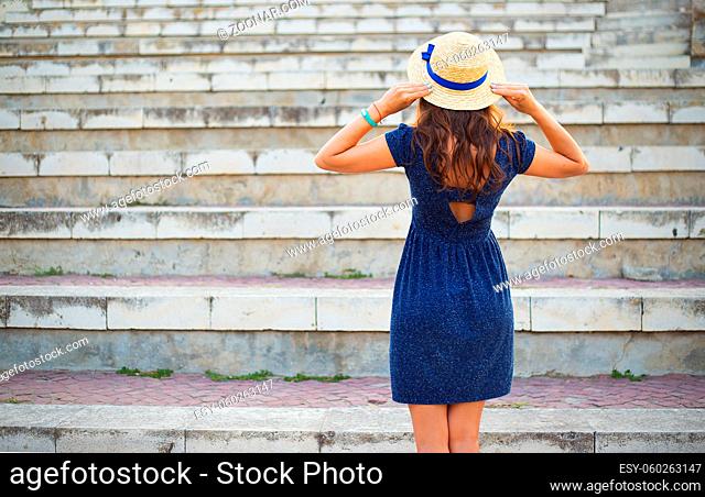 The girl stands with her back in the amphitheater. Bulgaria, Nessebar