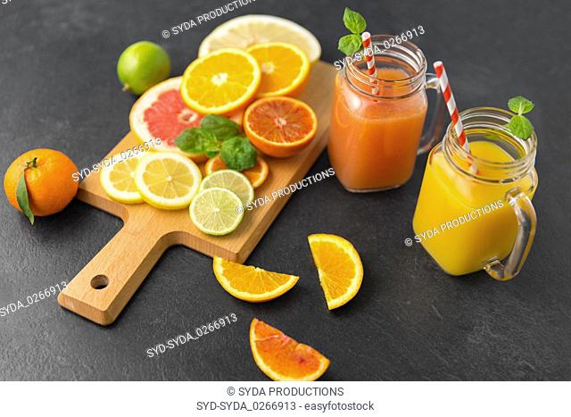 mason jar glass with juice and fruits on table