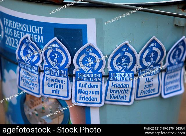 17 December 2023, Saxony-Anhalt, Halberstadt: View of patches with the inscription ""Peace Light from Bethlehem 2023"". The motto of this year's Peace Light...